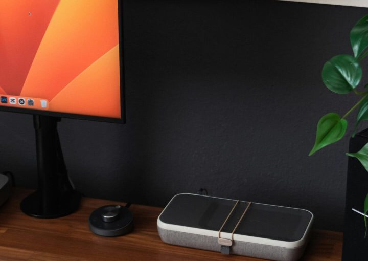 a desk with a laptop, keyboard, mouse and a monitor